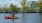 Two people kayaking in a river near our apartments for rent in Boston. The city skyline can be seen in the background.