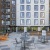 Exterior courtyard featuring grilling stations, lounge seating and views of the Charles River