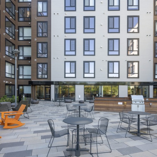 Exterior courtyard featuring grilling stations, lounge seating and views of the Charles River Exterior courtyard featuring grilling stations, lounge seating and views of the Charles River